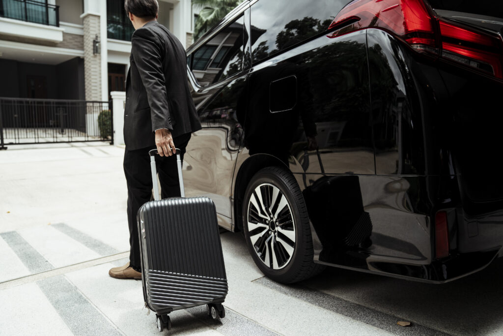 man standing by car city